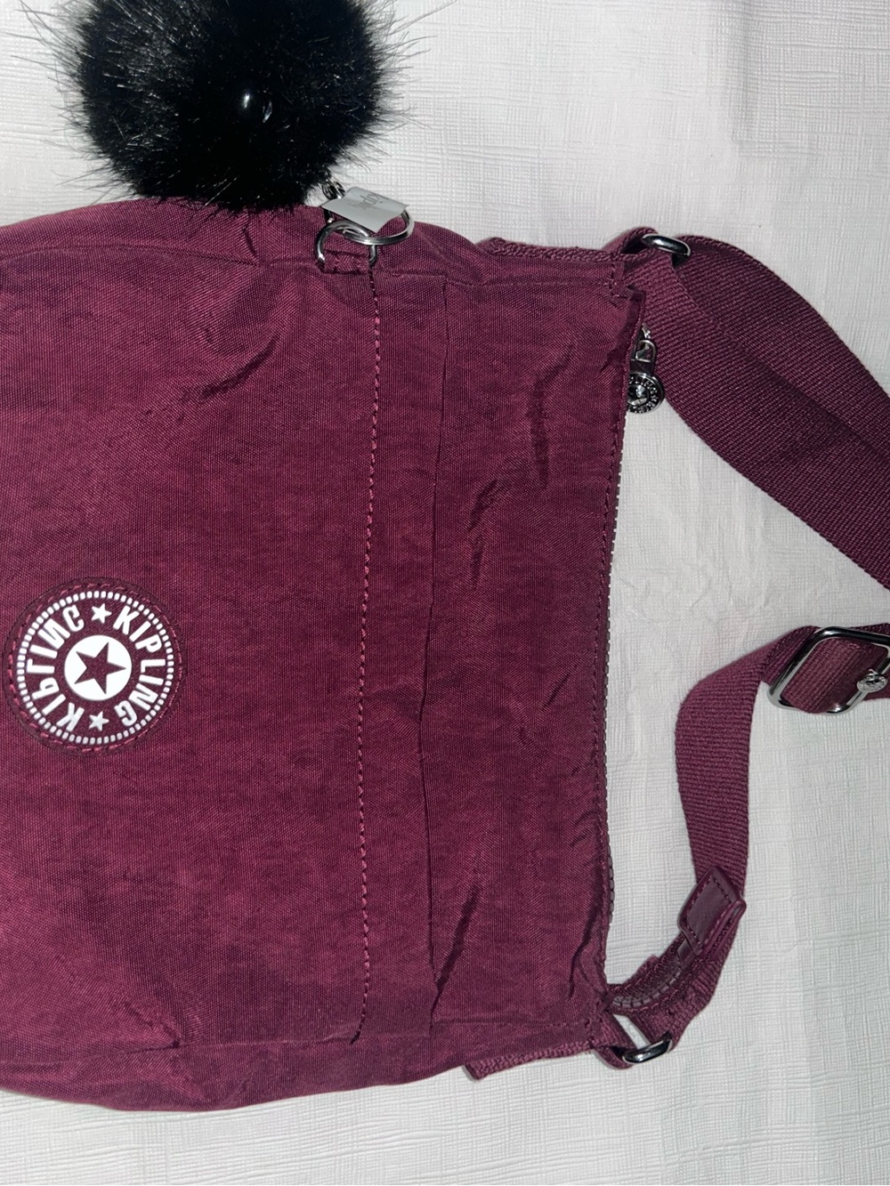 Kipling Plum Crossbody Bag with Pom Pom Accent monkey